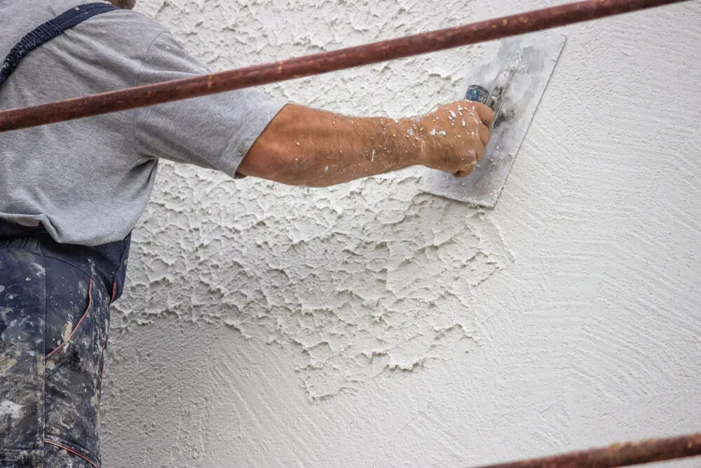 Painter using paint primer on wall