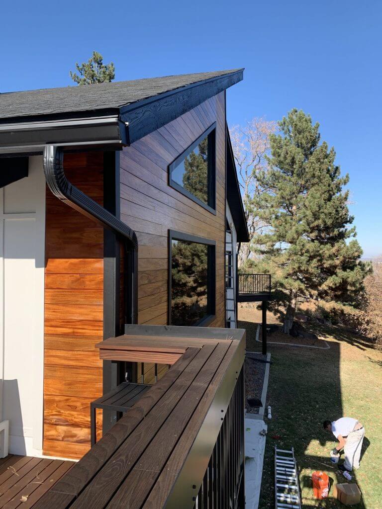 Exterior painting in Denver on a wood exterior with a sideview from the back porch by Imhoff Painting.