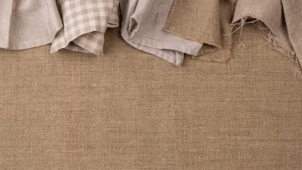 A photo of different cloths that can be used as drop cloths for painting.