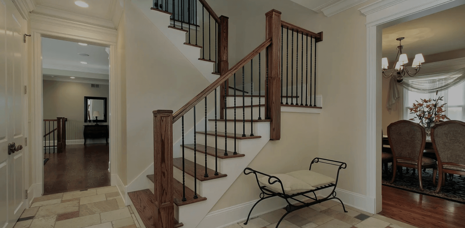 Freshly painted stairwell and dining room with neutral beige walls and white trim in a Denver home