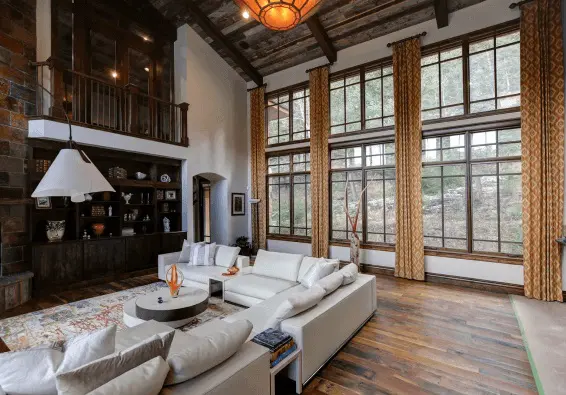 Modern rustic Denver living room with freshly painted white walls, tall windows, and wood accents