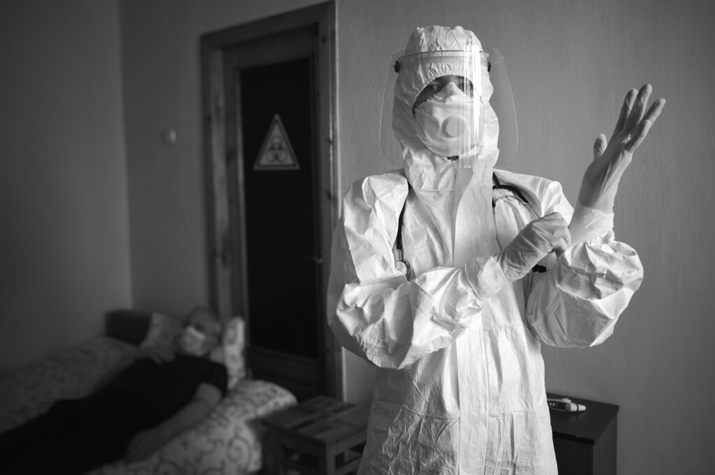 A person putting on protective gear to protect themselves from breathing in or touching asbestos.