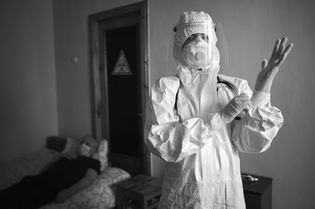 A person putting on protective gear to protect themselves from breathing in or touching asbestos.