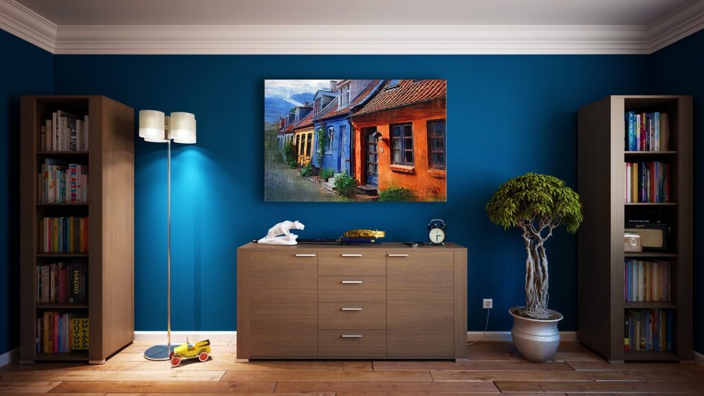 Beautiful blue, untextured and smooth wall with artwork hanging.