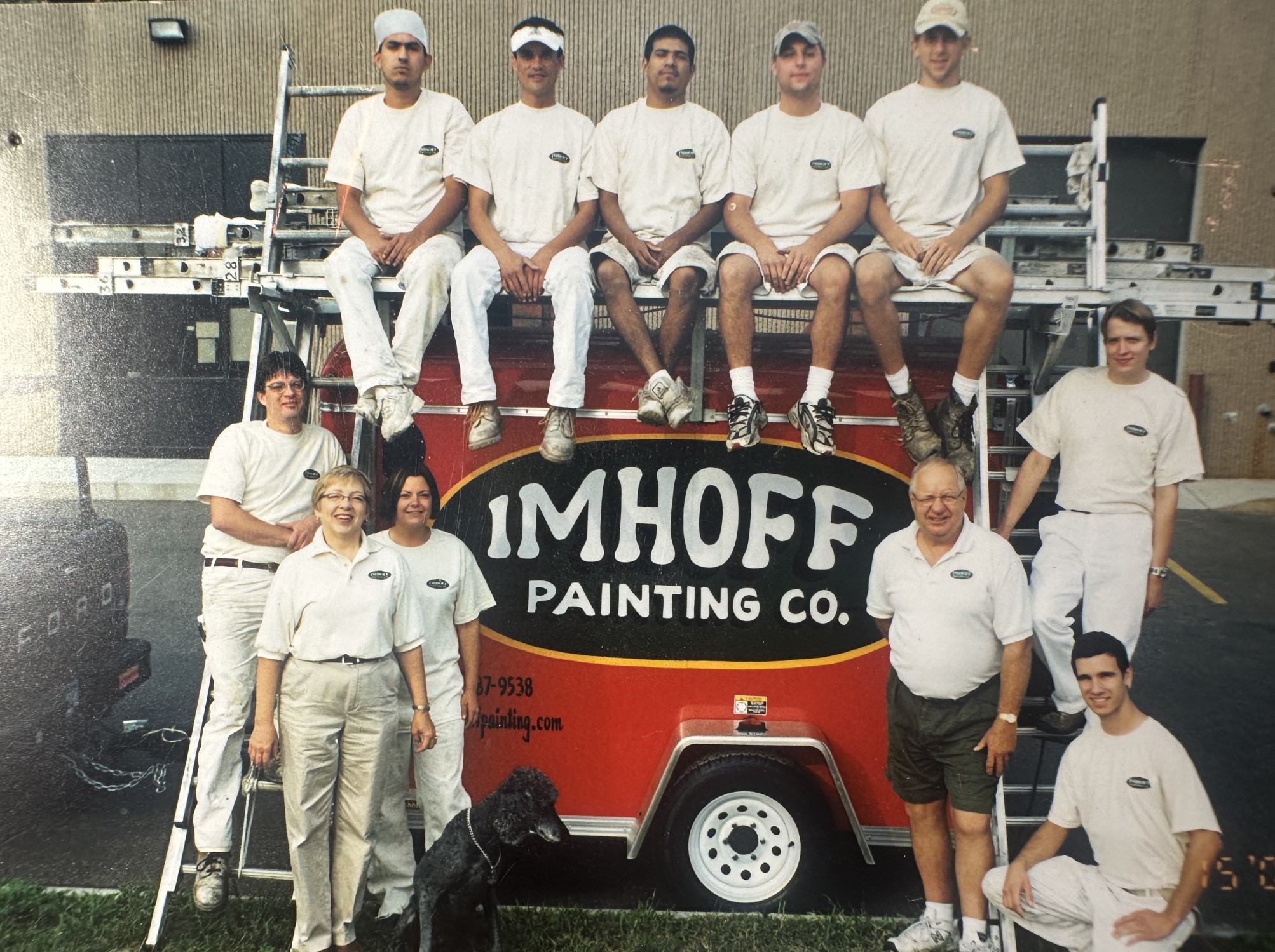 Imhoff Painting Company crew gathered around a red company trailer in Minnesota